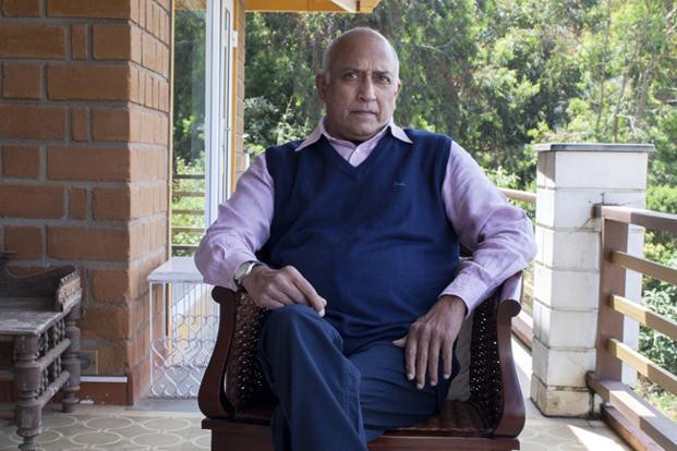 Rakesh Sharma sitting on a bench in front of a building